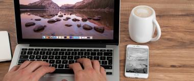 person keyboard laptop